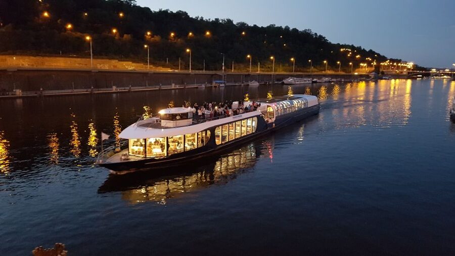 Prague: City Tour and Dinner Cruise with Hotel Pickup - Boarding the boat on the Vltava
