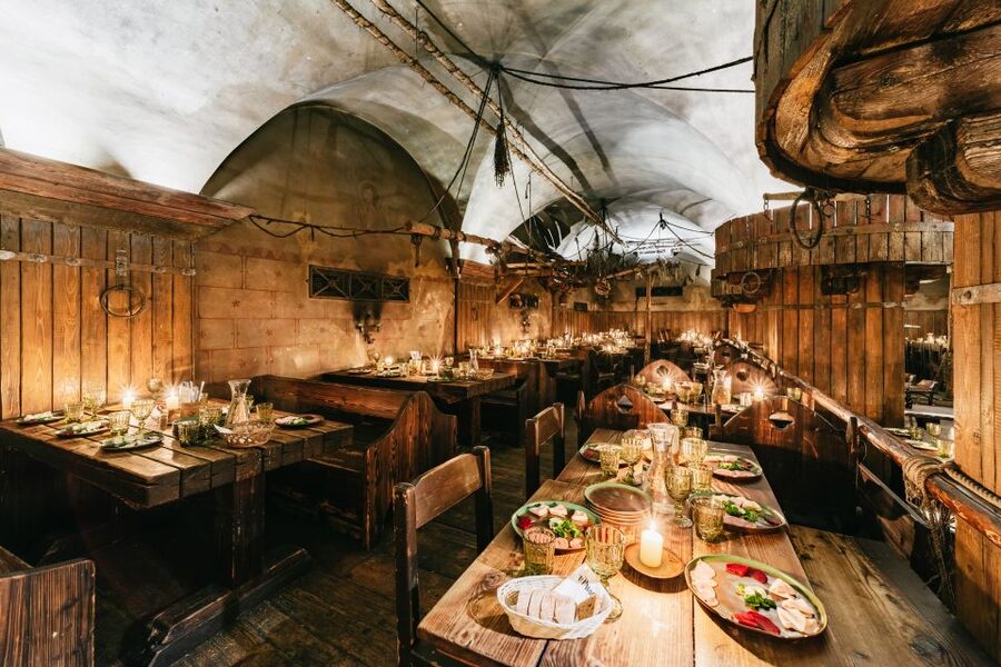 Prague: Medieval Dinner with Unlimited Drinks - The low light is part of the charm, and a drawback