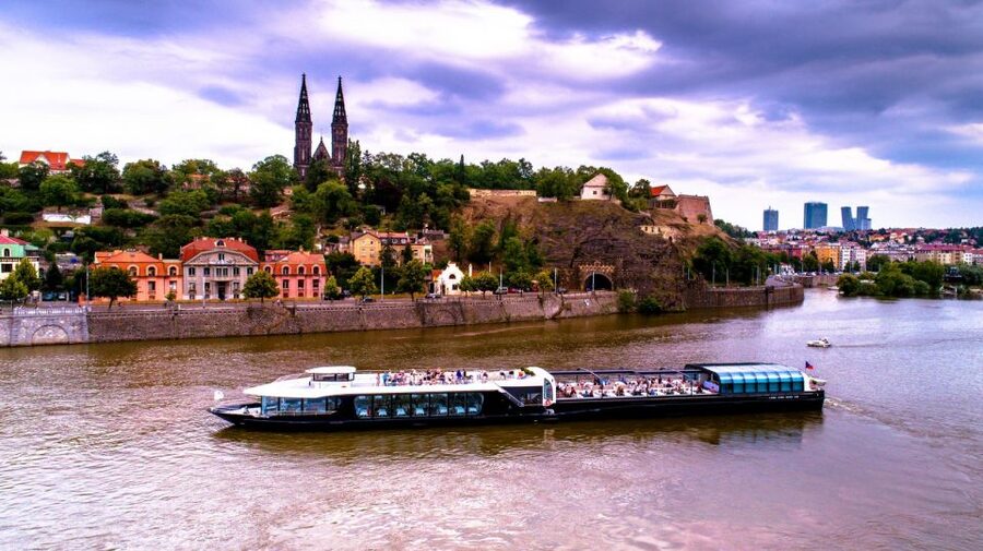 Prague: Sightseeing Dinner Cruise on Open-Top Glass Boat - The welcome drink and seating choices