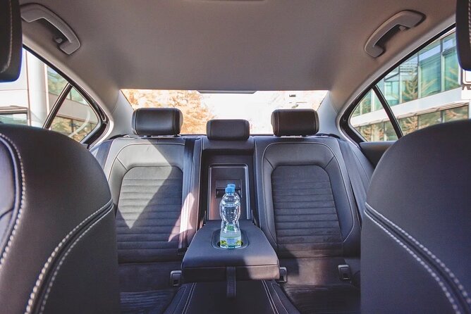 Private ROUND-TRIP (FROM and TO the AIRPORT) by LIMOUSINE 3+1pax - Arriving at Prague Airport with a name sign