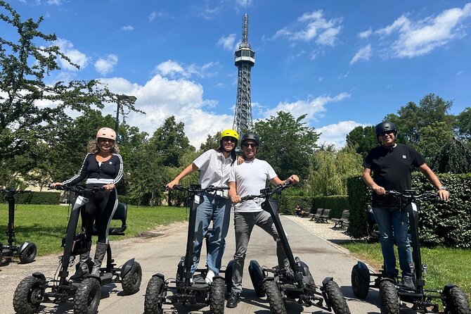 Scooter tours to Prague Castle and views. - Pausing beside the Vltava